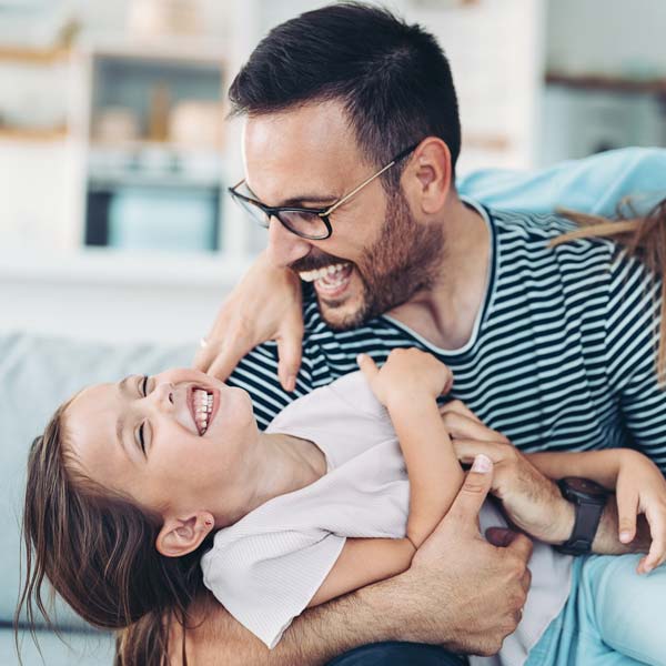 person and daughter laughing